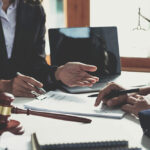 Business owner meeting with a lawyer to review and sign a personal guarantee on a business loan