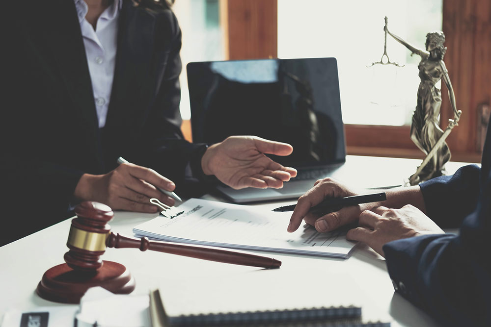 Business owner meeting with a lawyer to review and sign a personal guarantee on a business loan